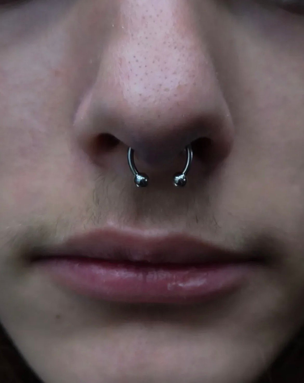 Septum piercing with circular barbell jewelry