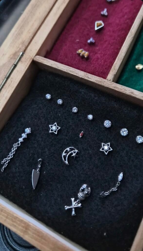 Assorted piercing jewelry arranged in a display tray