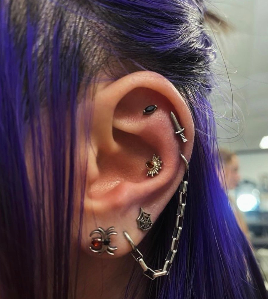Coordinated jewelry worn in multiple ear piercings
